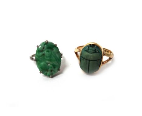 An 18ct gold ring, mounted with a faience scarab, London 1926, ring size Q and a half and a white gold ring, claw set with a 