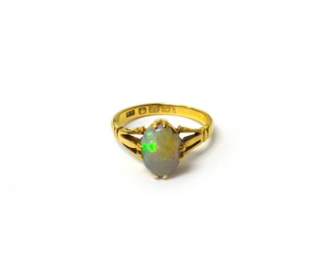 A gold ring, claw set with an oval opal between pierced shoulders, ring size O, with a case.