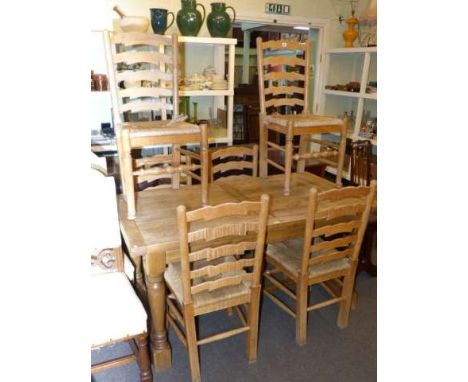 Oak draw leaf dining table and six ladder back rush seated dining chairs