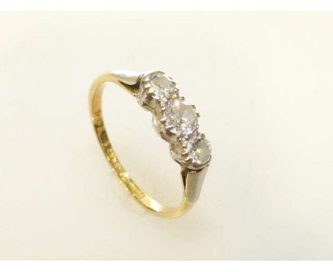 Three-stone diamond ring, stamped 18CT and PLAT, size J½