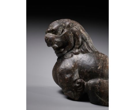 A BROWN LIMESTONE FIGURE OF A SEATED LION, TANG DYNASTY 唐代石獅China, 618-906. The muscular animal shown seated, the head turned