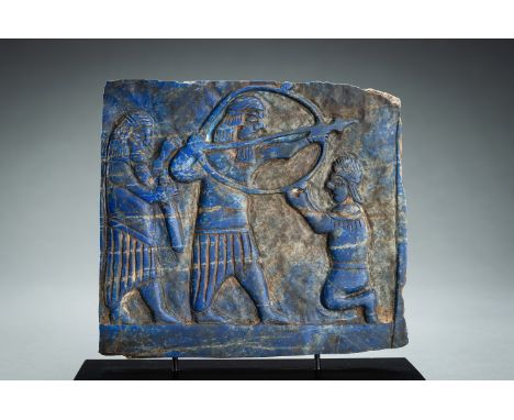 A LAPIS LAZULI FRIEZE WITH WARRIORSWestern Asiatic region, presumably 7th century. Of irregular rectangular form, carved in r