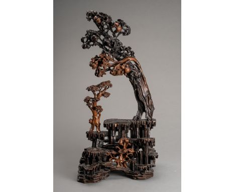 A LARGE CARVED BURLWOOD DISPLAY STANDChina, late Qing Dynasty (1644-1912). Naturalistically carved and consisting of three pa