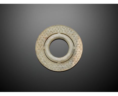 A JADE DOUBLE DISK, BI, WARRING STATES TO WESTERN HAN DYNASTYJade. China, Warring States period to Western Han dynasty, 5th c