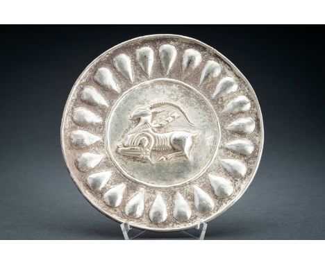A PERSIAN SILVER REPOUSSE 'ANTELOPE' DISHPersia, 17th century or earlier. The dish with shallow sides, decorated to the rims 