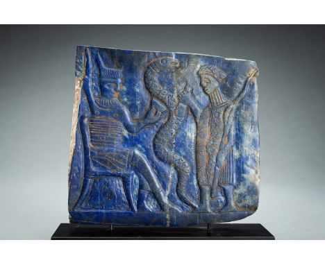 A LAPIS LAZULI FRIEZE OF A DIGNITARY WITH SNAKEWestern Asiatic region, presumably 7th century. Of irregular rectangular form,