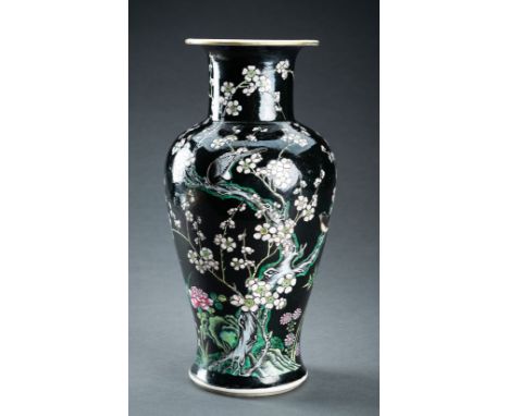 A FAMILLE NOIR BALUSTER VASE, QINGChina, Qing Dynasty (1644-1912). The baluster sides rising from a spreading foot to a waist