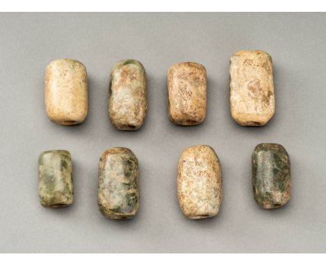 A LOT WITH EIGHT ANCIENT CHINESE JADE BEADSChina, presumably Neolithic, 3rd millennium BC. Different in size and of irregular