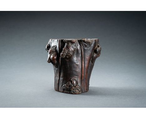 A WOOD "TREE TRUNK WITH BATS AND LINGZHI" BRUSHPOT, BITONG, 17th CENTURYChina, 17th century. Naturalistically carved in high 