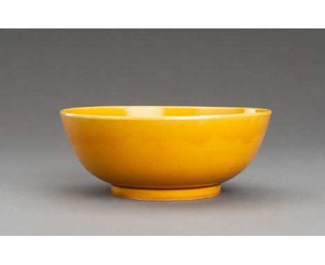 A FINE YELLOW-GLAZED PORCELAIN BOWLChina, Qing Dynasty (1644-1912). With deep rounded sides rising from a short foot to a str