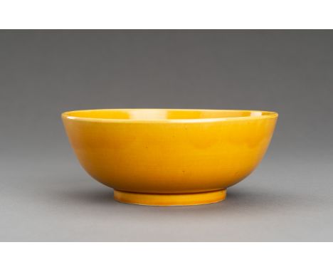 A FINE YELLOW-GLAZED PORCELAIN BOWLChina, Qing Dynasty (1644-1912). With deep rounded sides rising from a short foot to a str