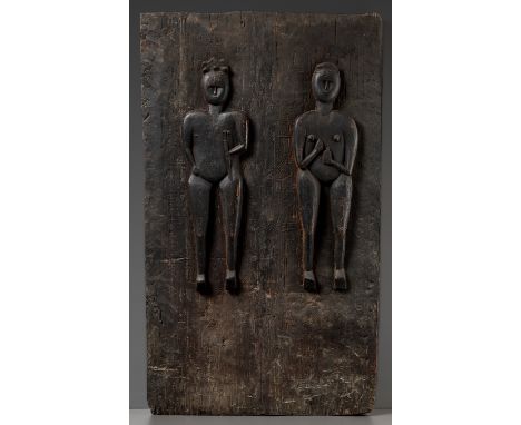 A RARE AND LARGE CARVED HARDWOOD 'MALE AND FEMALE' DOOR, ODA MATANTimor, Belu Regency, late 19th century. Expressively carved