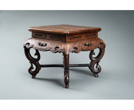 A HARDWOOD DISPLAY STAND, QINGChina, Qing Dynasty (1644-1912). The top panel supported on a reticulated apron carved with ruy