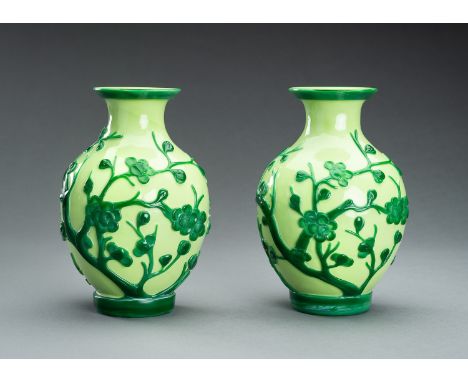 A PAIR OF GREEN OVERLAY PEKING GLASS 'PRUNUS' VASES, GUANGXU MARK AND PERIODChina, Guangxu period (1875-1908). The pair of ov