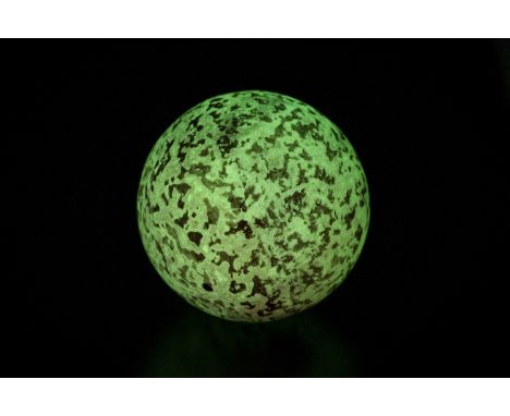 A 'GLOWING IN THE DARK' STONE SPHEREOf near perfect spherical form, it can easily absorb light (both sunlight and artificial)