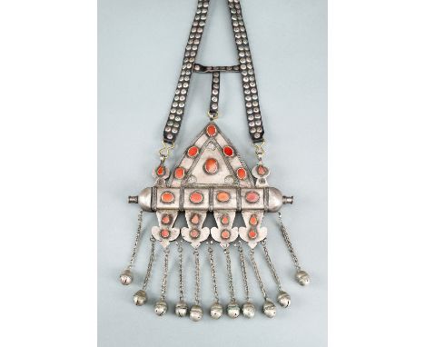 A TURKOMAN SILVER AND CARNELIAN AMULET HOLDER, c. 1900sTurkmenistan, late 19th to early 20th century. The triangular-shaped p