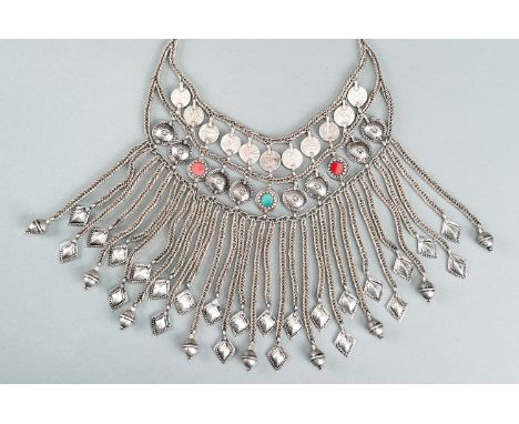 A TRIBAL AFGHAN MULTI-STRAND SILVER NECKLACE WITH GLASS INSETS, c. 1950sAfghanistan, mid-20th century. Consisting of a silver