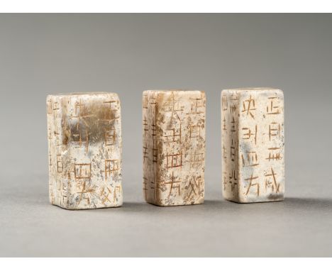 A GROUP OF THREE ARCHAISTIC CONG-FORM BEADSChina, 20th century. All of square section, carved as miniature congs, each regist