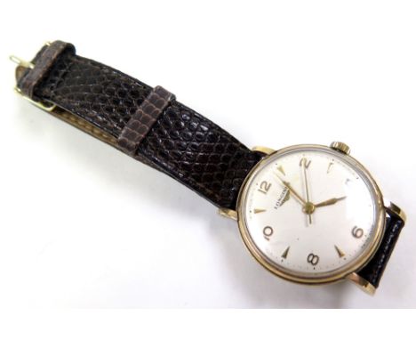 Gents 9ct gold Longines wristwatch with baton and arabic numerals, engraved on back for 25 years service, on a brown leather 