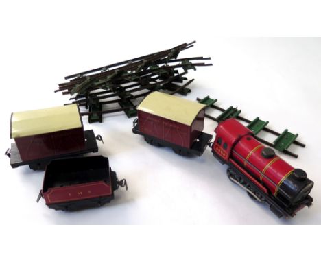 Chad Valley clockwork train set, comprising engine (3402) and tender, two carriages and eight piece track circuit, comes with