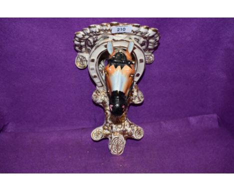 A continental styled wall sconce or bracket in the form of a horse head hand painted and in good condition
