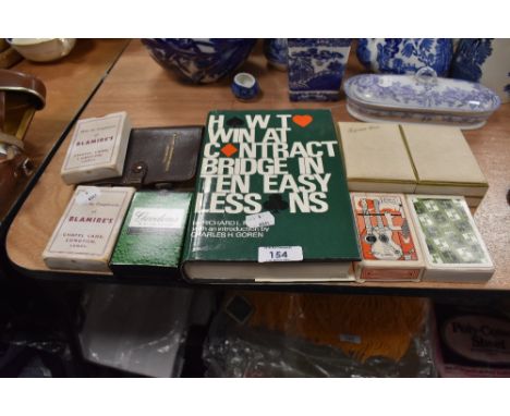 A selection of playing cards and Bridge related text book