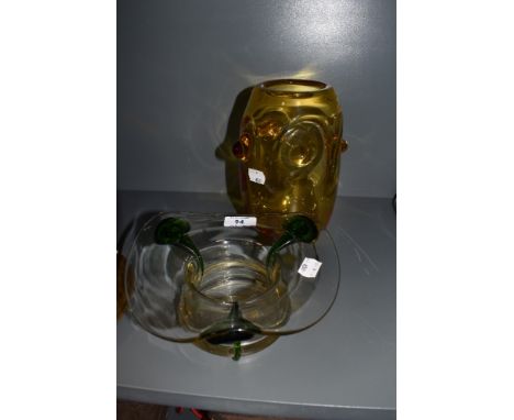 Two pieces of art glass a yellow knopped White Friars style mid century vase and green stripped art nouveau style squat vase
