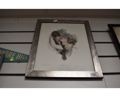 A framed art deco print titled first kiss