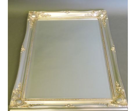 A silver framed wall mirror containing a bevelled rectangular plate, W. 92cm