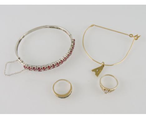 A ruby set bangle, the twin row of claw set stone on a white metal band stamped 925, together with a diamond dress ring, the 