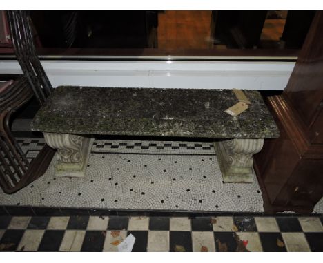 A Victorian style reconstituted stone garden bench on 'S' scroll end standards, L. 115cm.