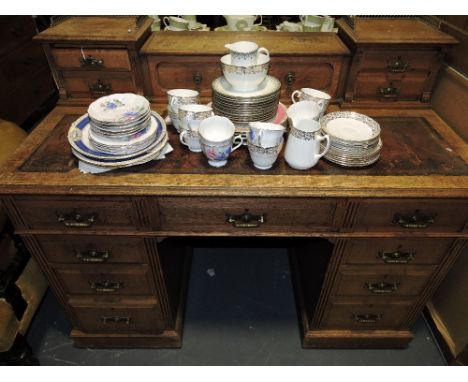A late Victorian oak kneehole desk, the brass galleried superstructure with hinged inkwell compartment over central drawer fl