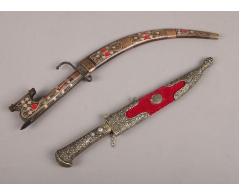 Two daggers. An Eastern curved dagger in wooden sheaf &amp; a turkish dagger with metal decoration to sheaf &amp; handle.  