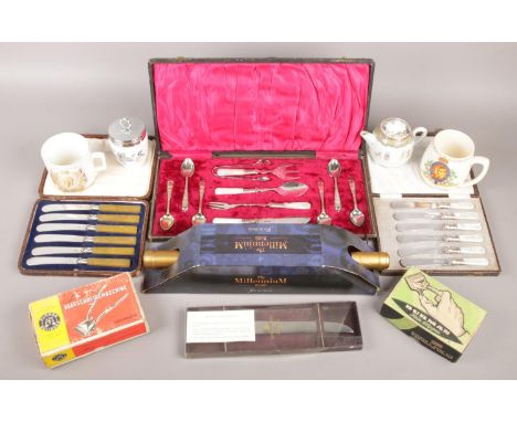 A box of miscellaneous. Includes cased cutlery, commemorative mugs, vintage clippers, Millennium Bottle etc.  