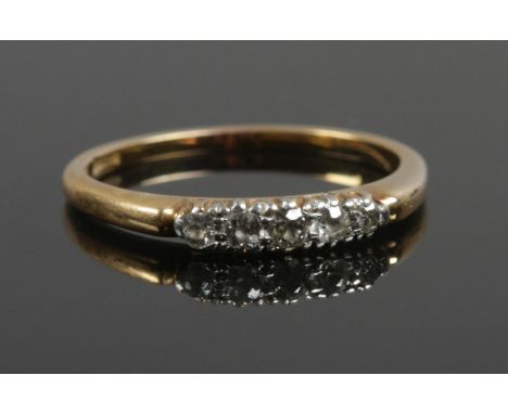 A yellow metal five stone diamond ring. Size M. 2.29g.  Bears stamp but indistinct.