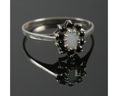 A Silver Opal and possibly Sapphire cluster ring. Assayed in Birmingham by KR. Size: Q. Total weight: 1.53g.  
