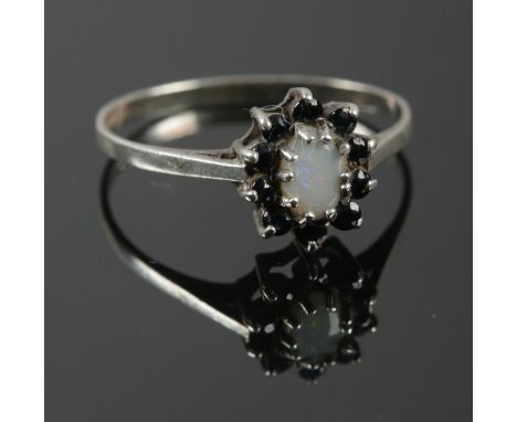 A Silver Opal and possibly Sapphire cluster ring. Assayed in Birmingham by KR. Size: Q. Total weight: 1.53g.  