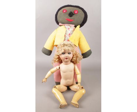 A vintage jointed doll, along with a soft toy.  