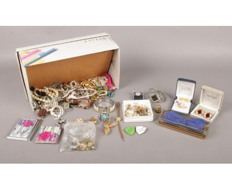 A box of assorted costume jewellery. To include an 18ct gold plated brooch with Opal, necklaces, bracelets, enamel badges and