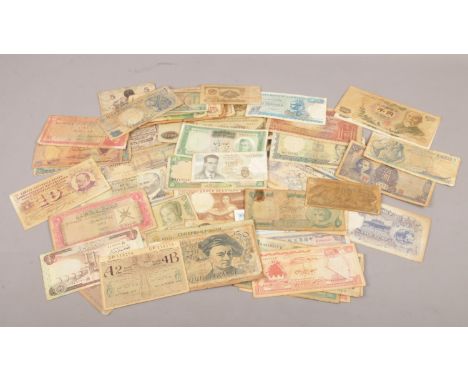 A collection of vintage world bank notes. Lire, Yuan, Francs, dollars etc  