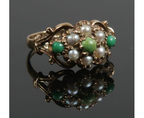 A 9ct gold cluster ring set with seed pearls and green coloured stones. Size N. 3.13g.  