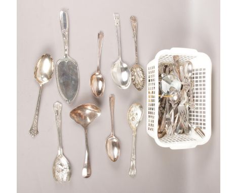 A box of flatware. Including berry spoons, ladle, etc.  