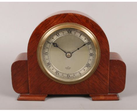 A small mahogany cased Elliott mantle clock, raised on stepped feet. 15cm high. In working order.  
