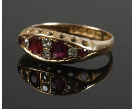 An 18ct gold diamond and red coloured stone ring. Size L. 2.81g.  