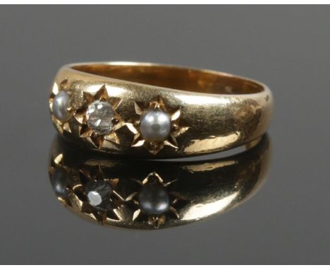 An 18ct gold diamond and seed pearl ring. Size M 1/2. 5.11g.  