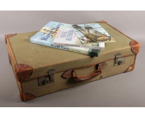 A vintage canvas and leather bound Navy suitcase. With contents of three naval books.  