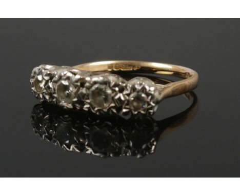 An 18ct gold four stone diamond ring, illusion set. Size P. 4.23g.  