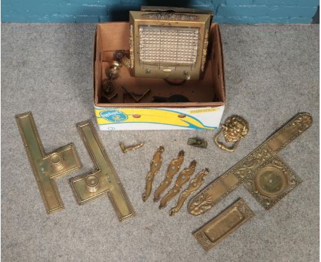 A box of metalwares. Including ornate brass push plates, small metal wood plane, lion mask door knocker, handles, etc.  