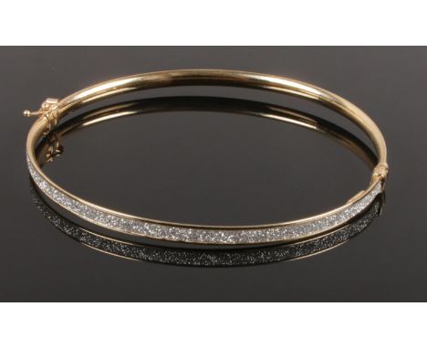 An Italian Milor 9ct gold bangle. With encrusted decoration.  