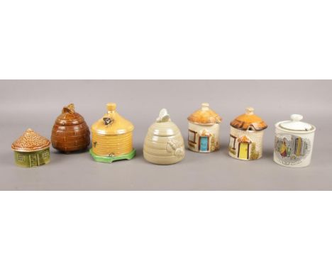 A collection of six honeypots and another similar example.  To include Crown Devon, Adams, and a Holkham lidded ceramic house